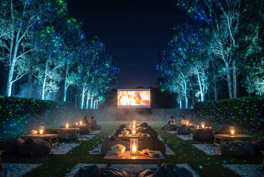 Backyard movie night under green and blue laser stars