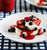 Cute mini berry pavlovas with strawberry sauce