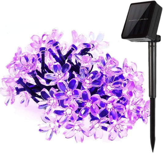 Purple blossom solar string light lit, with solar panel and stake