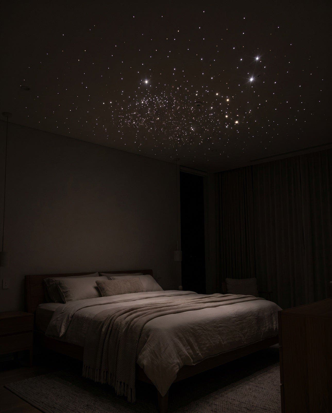 Bedroom ceiling covered in a dense field of white laser stars at night
