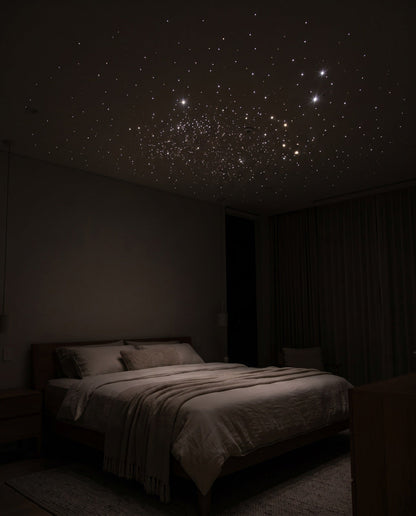 Bedroom ceiling covered in a dense field of white laser stars at night